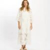 White eyelet lace maxi dress worn by a woman, featuring wide sleeves and a relaxed fit, on a plain white backdrop