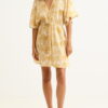 Beige kimono-style dress with yellow palm leaf print, V-neck and waist tie, worn by a barefoot model.”] ,