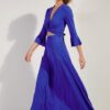 Model wearing a royal blue wrap-top maxi dress with 3/4 bell sleeves, walking across a white studio background.