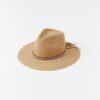 Straw sun hat with a brown beaded wraparound band on a white background.