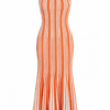 Orange and white vertical striped sleeveless mermaid dress on a white background, form-fitting through the hips and flaring at the hem.