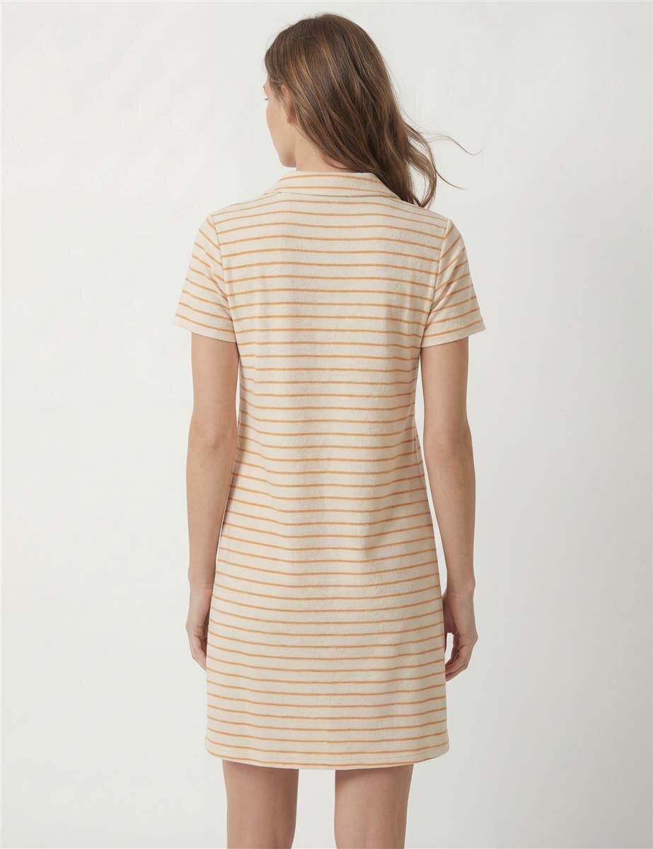 Back view of a woman wearing a beige polo dress with thin orange horizontal stripes.